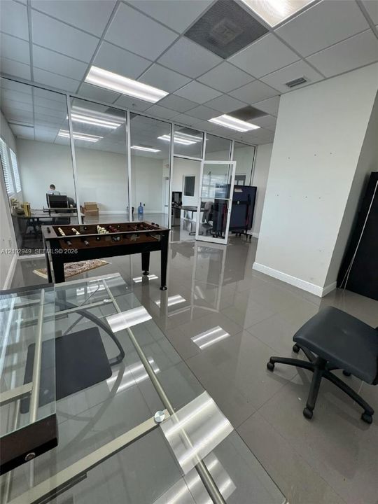 Office second level space featuring large-format tile flooring.