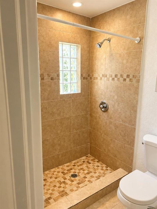 Warmly Lit Beige Tile Shower