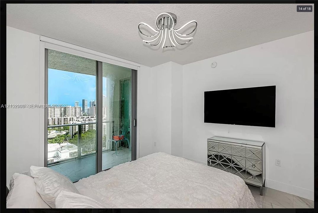 Floor-to-ceiling sliding glass doors, contemporary ceiling fixture, and hard-surface flooring