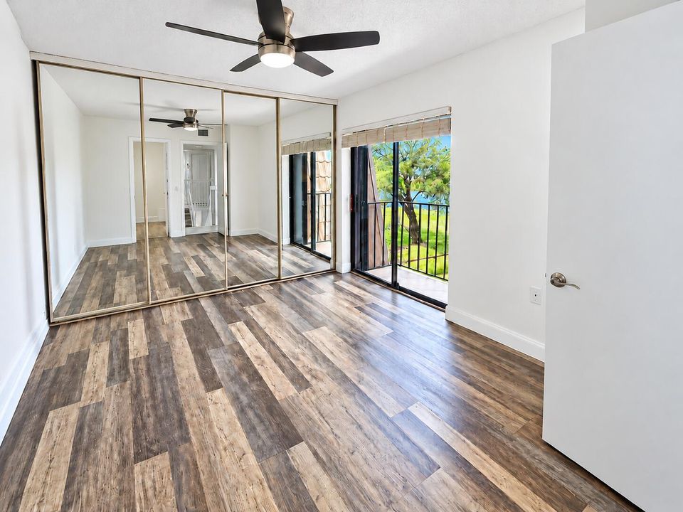 Guest Bedroom with water and patio view