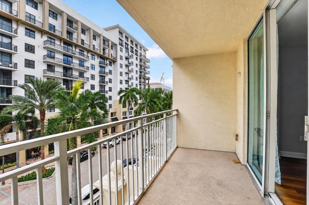 Sunlit Balcony Overlooking Palm-Lined Re