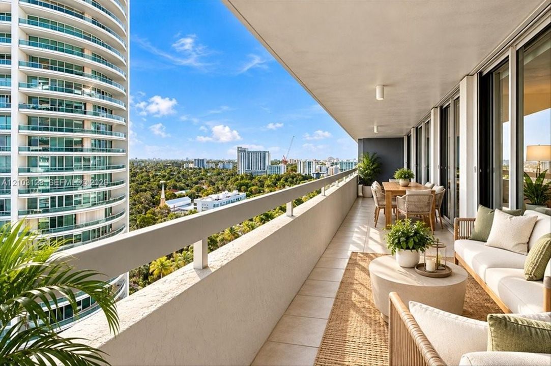 Expansive covered balcony featuring tile flooring, a solid wall railing with a metal top rail, and recessed ceiling lighting