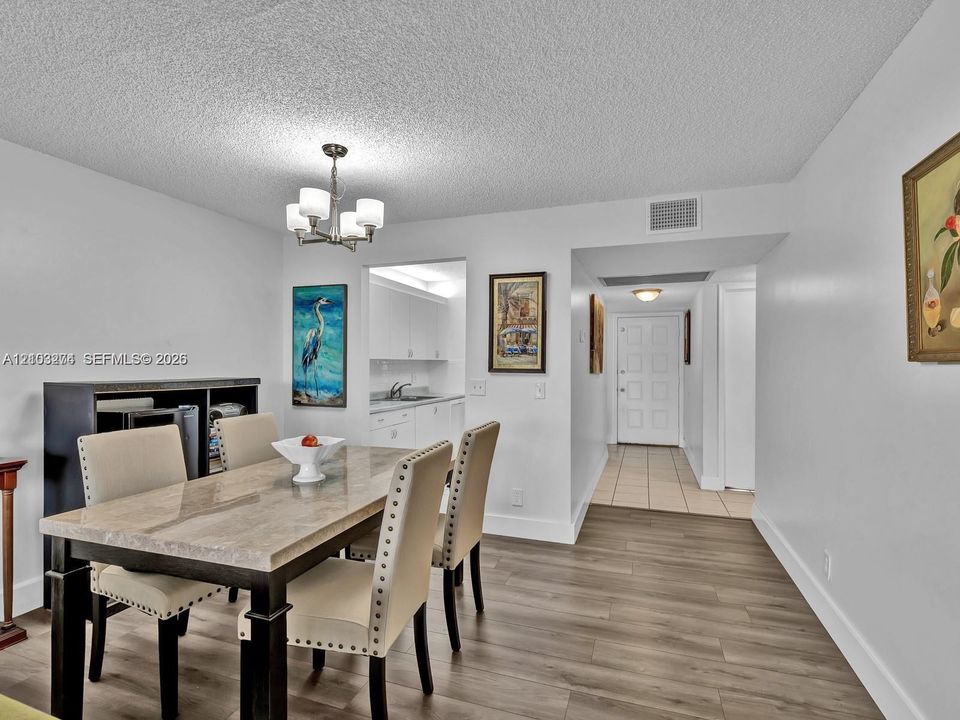 Interior space featuring wood-finish flooring, a multi-light chandelier, and a neutral color palette