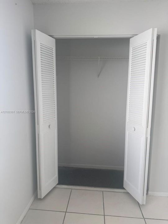 Closet featuring white louvered bifold doors and wire shelving