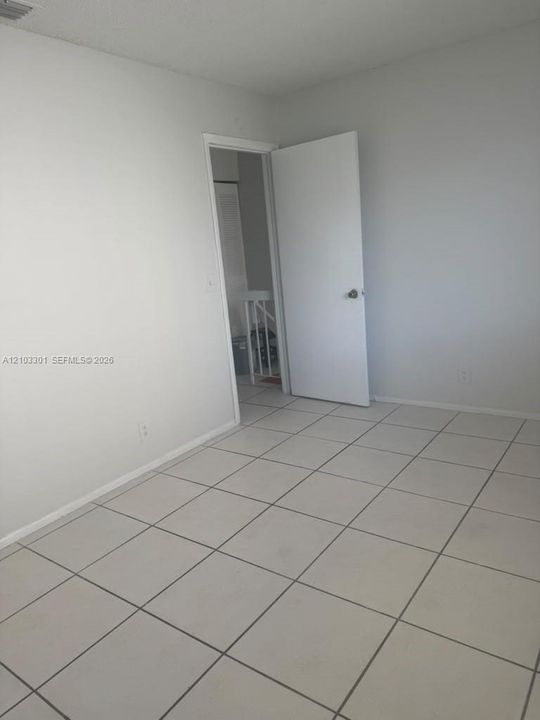 Room featuring neutral-toned walls and square ceramic tile flooring