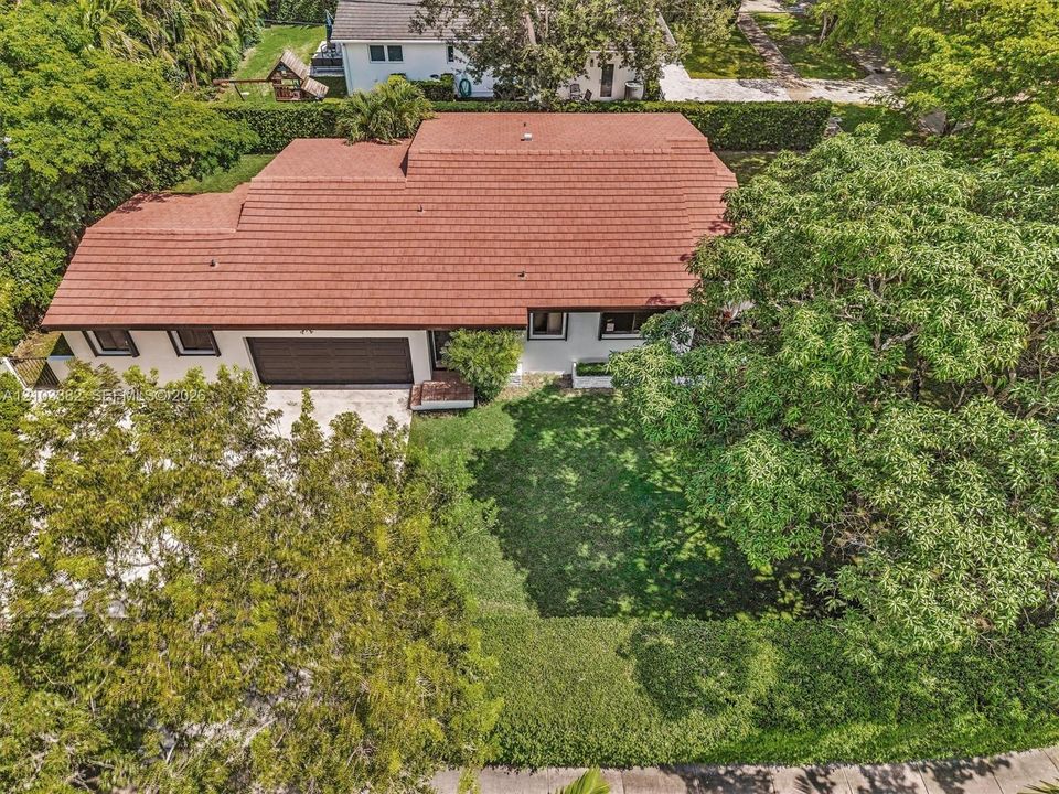 Single-story house for rent on a huge corner lot, featuring a tile roof, an attached two-car garage, and established landscaping.House for rent in Coral Gables. House for rent listed by Realtor.