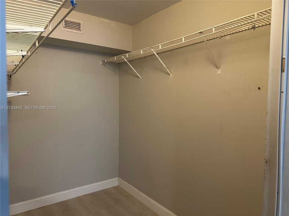 Storage space featuring wall-mounted wire shelving and neutral-toned wall paint