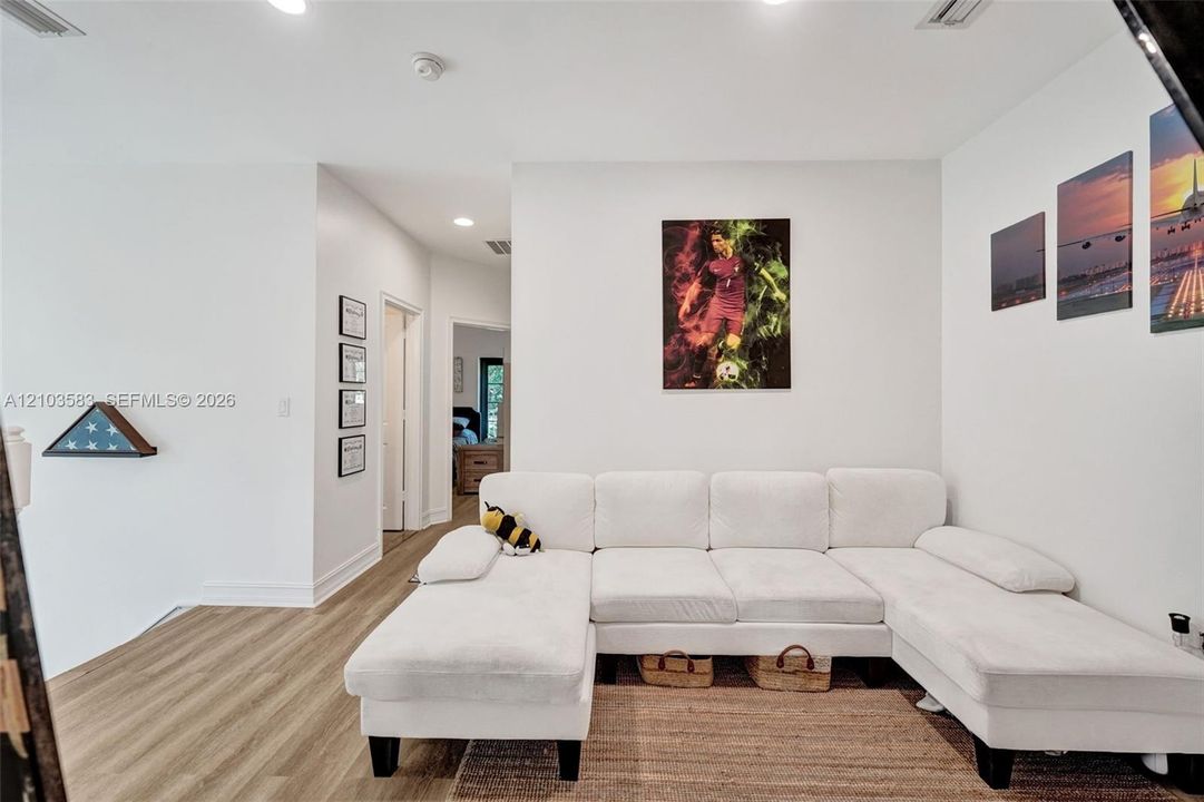 Interior space featuring high ceilings, recessed lighting, and wood-finish flooring