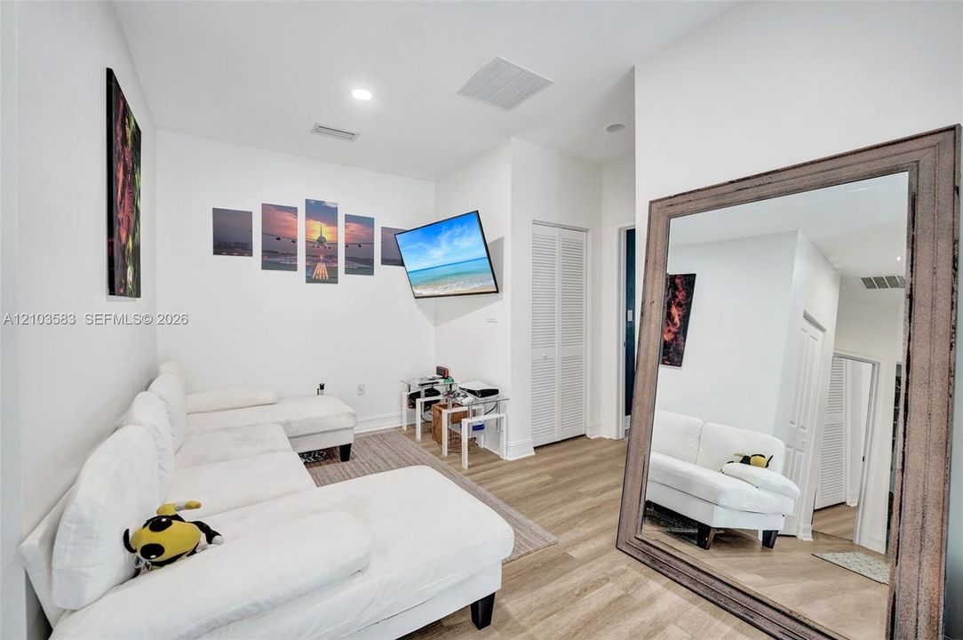 Interior space featuring wood-finish flooring, recessed lighting, and a closet with louvered doors