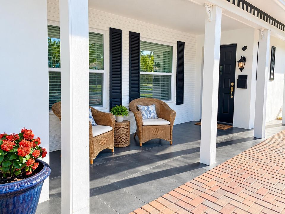 Sunlit Coastal Porch with Wicker Seating