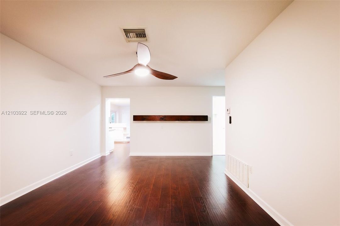 Recessed lighting, wood-finish flooring, and a ceiling fan with integrated lighting