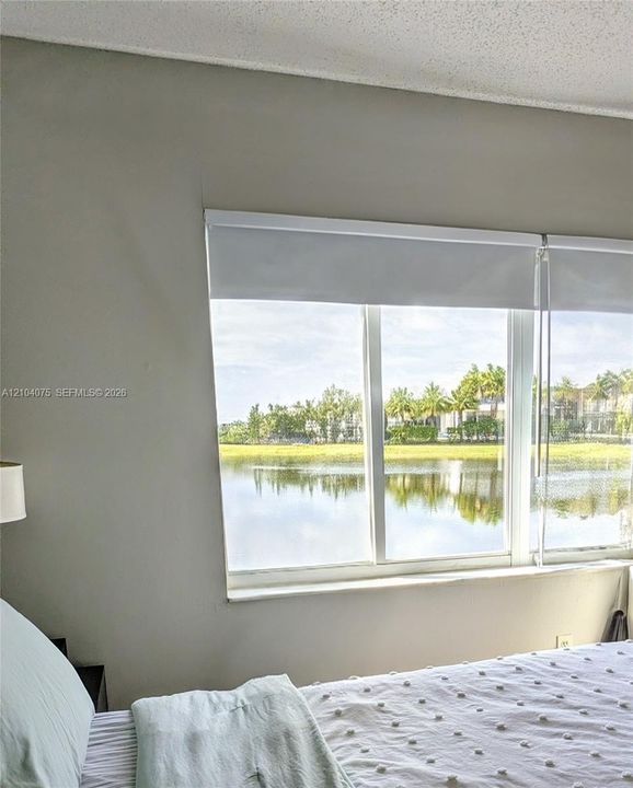 Large multi-pane window featuring water and landscape scenery