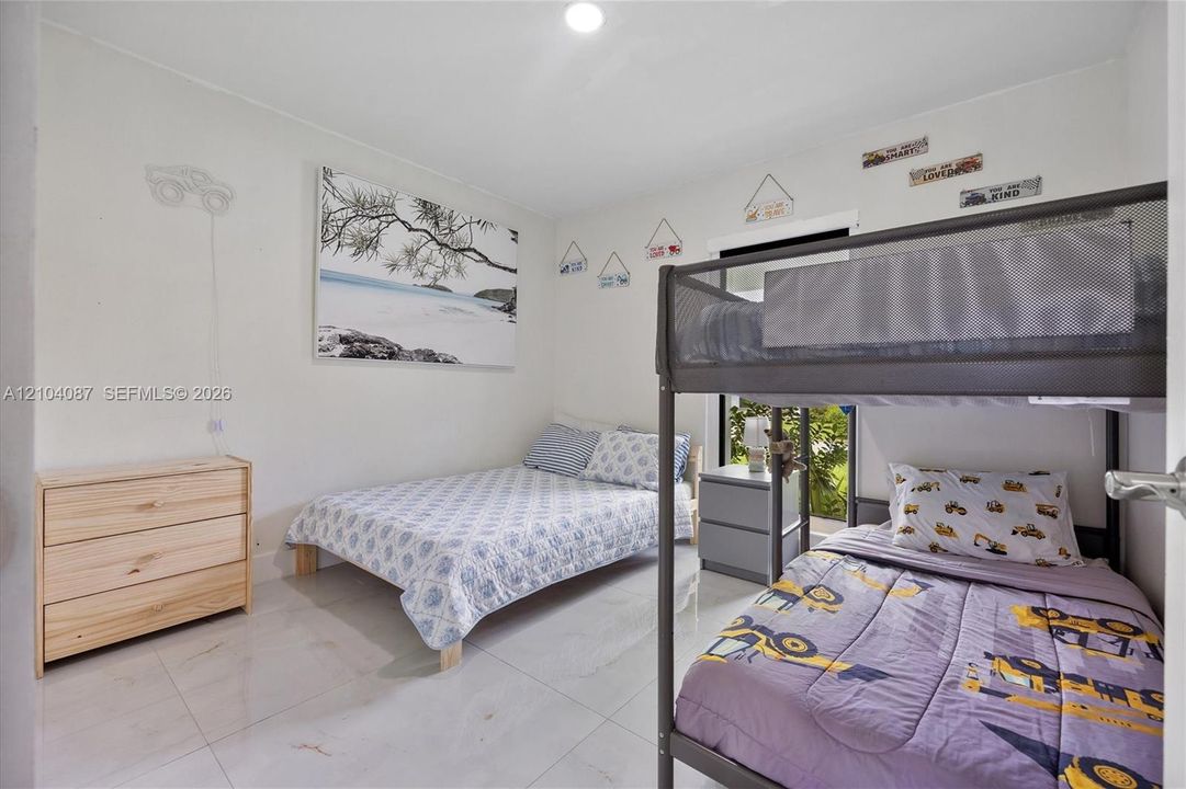 White walls and light-toned tile flooring create a bright interior