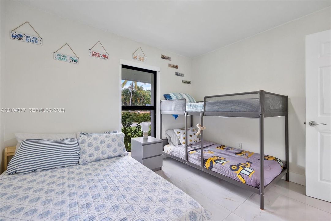 White walls with a single window featuring a dark frame