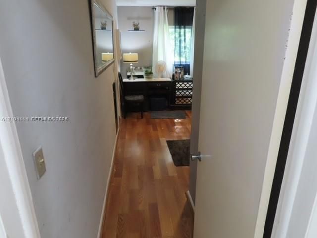 Interior room featuring wood-finish flooring and a window with natural light