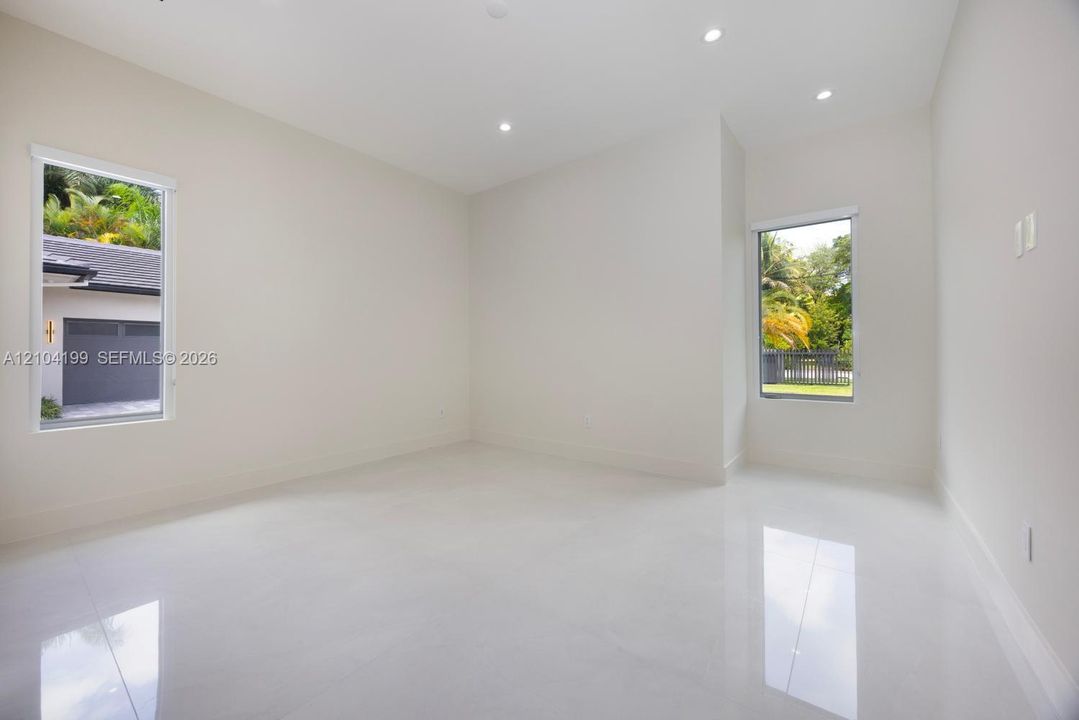 Neutral interior featuring glossy tile flooring, recessed lighting, and dual windows