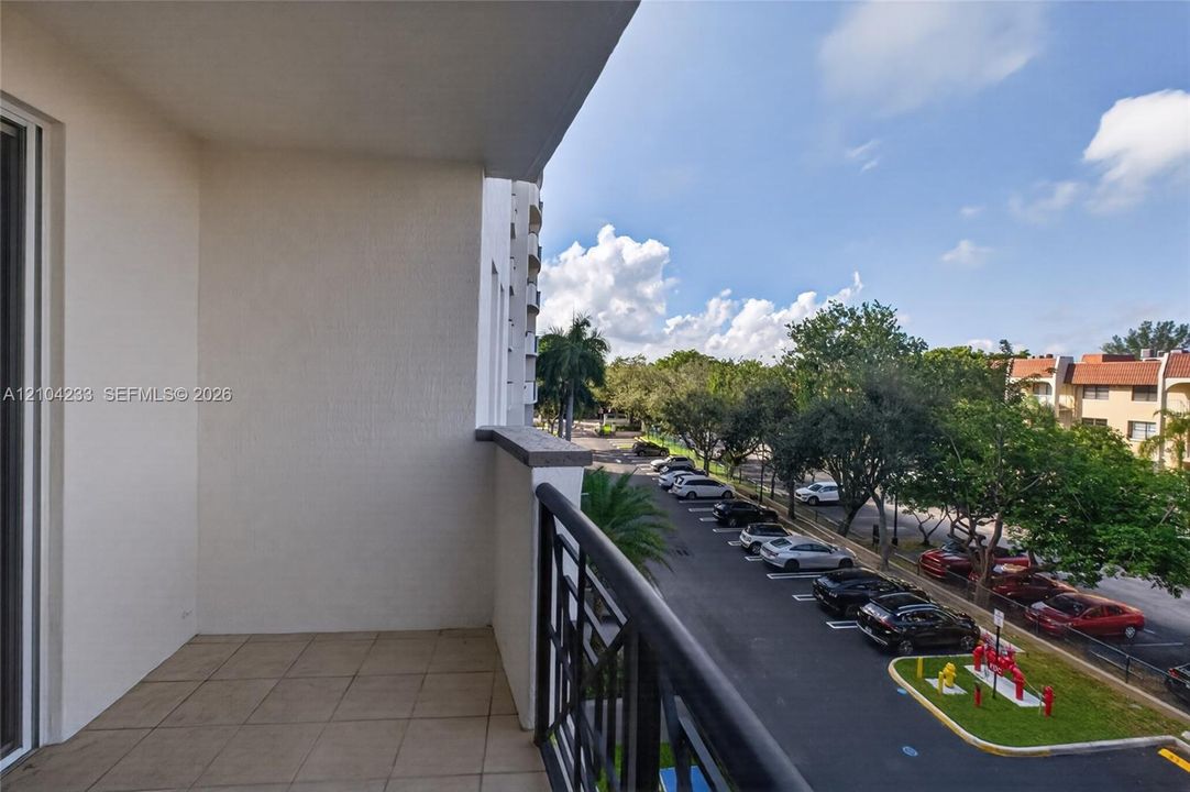 Private balcony featuring a tiled floor and a black metal railing
