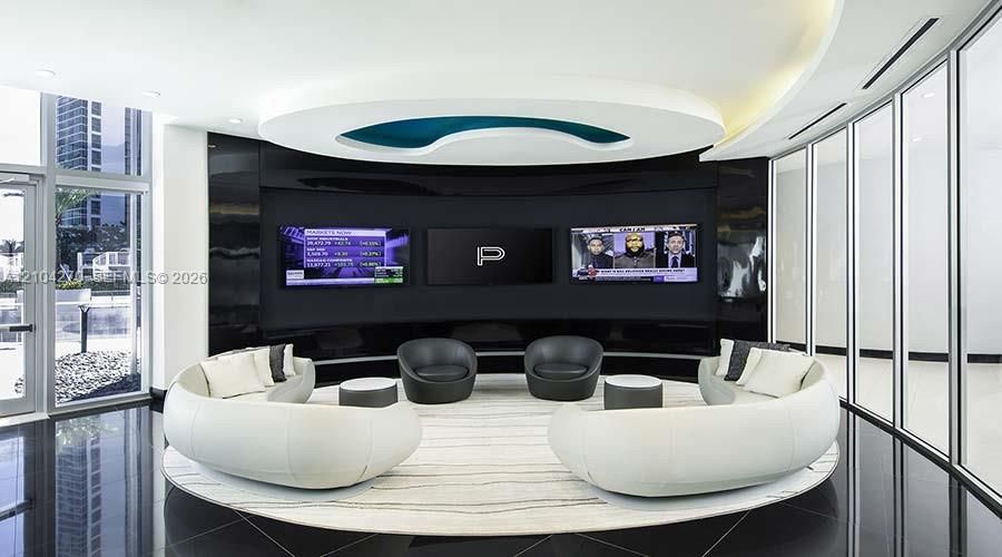Curved recessed ceiling with integrated lighting, high-gloss black wall paneling, floor-to-ceiling glass wall partitions, and polished tile flooring