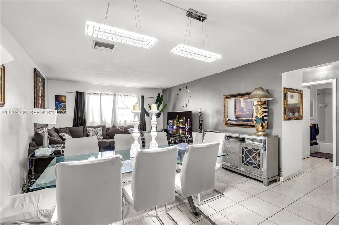 Large-format ceramic tile flooring, dual rectangular LED pendant lighting fixtures, and neutral interior paint palette