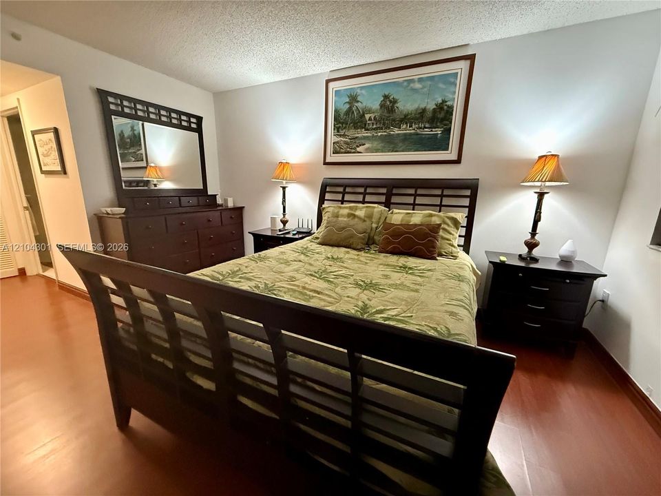 Bedroom featuring wood-finish flooring and neutral wall color