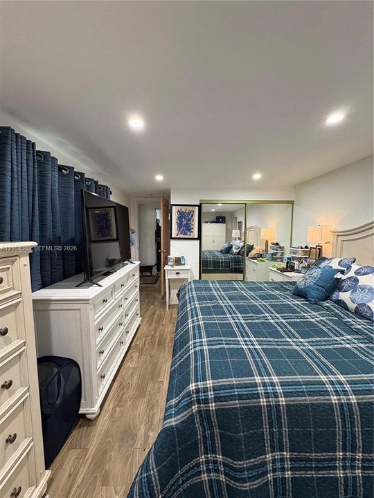 Interior space featuring recessed lighting, wood-finish flooring, and a mirrored closet with sliding doors