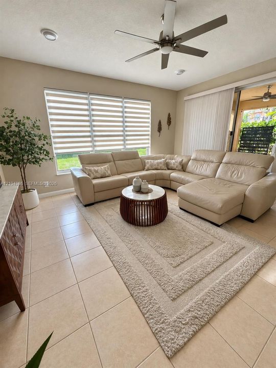 Wood-finish flooring, oval accent window, recessed lighting, and white painted railings with detailed balusters