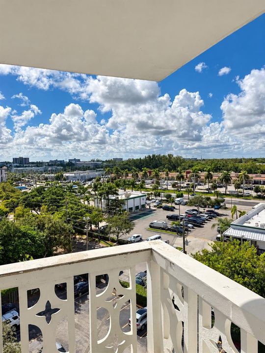Private balcony with decorative masonry railing and expansive outdoor exposure