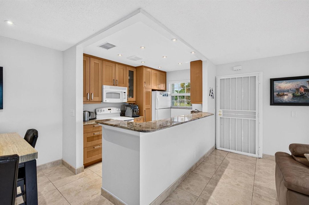 Open concept kitchen with granite counte