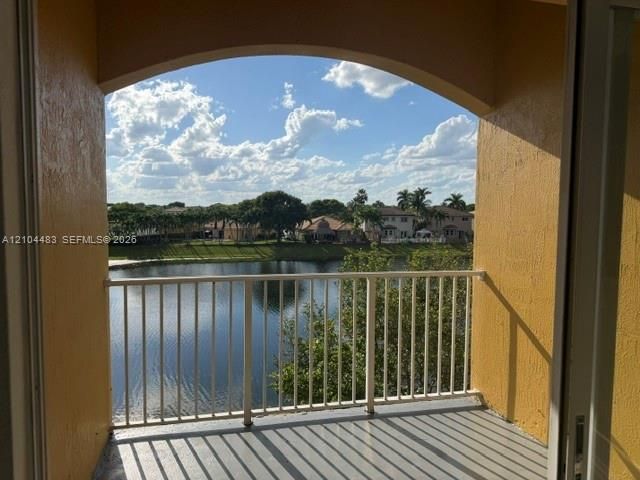 Balcony with lake frontage and a white railing