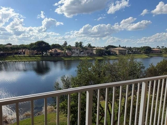 Waterfront property with a white railing