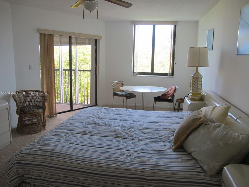 Carpeted flooring throughout, with a ceiling fan overhead