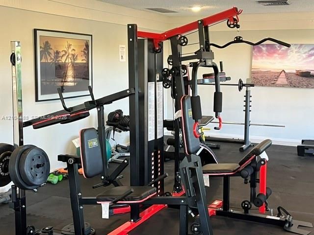 Fitness space featuring impact-resistant rubberized flooring and neutral wall finish