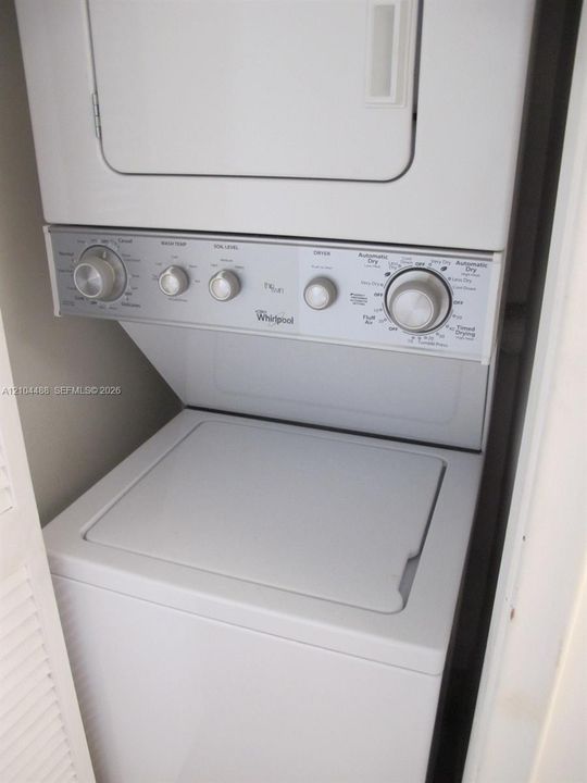 Stacked white washer and dryer unit