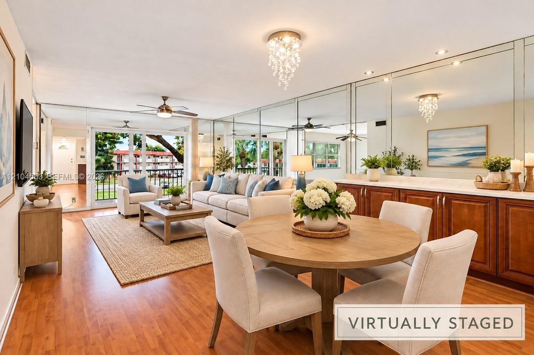 Wood-finish flooring throughout, mirrored accent wall, built-in cabinetry with counter surface, and a private balcony