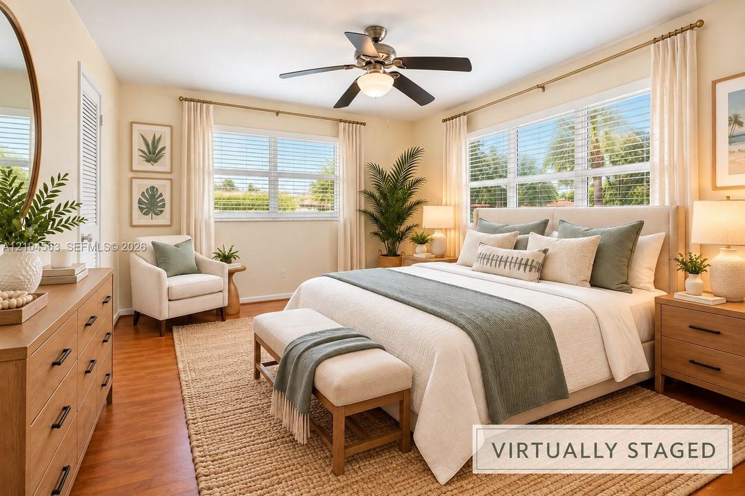 Hardwood-finish flooring, ceiling fan with integrated lighting, multiple windows with blinds, and white door with louvered paneling