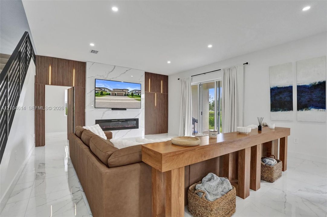 Recessed lighting illuminates the white tile flooring