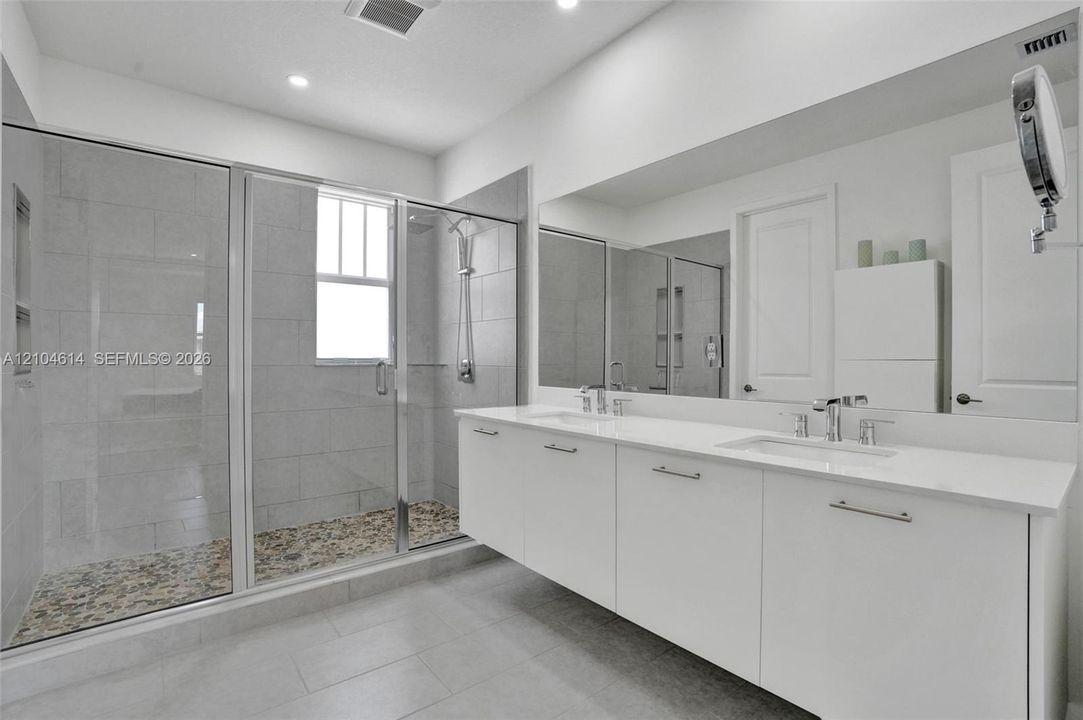 Floating double vanity with a white countertop and chrome fixtures
