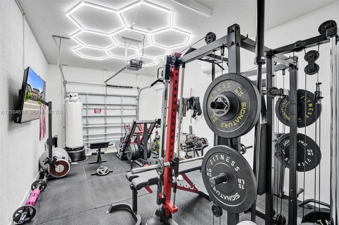 Rubberized flooring, hexagonal ceiling lighting, perfect for gym equipment