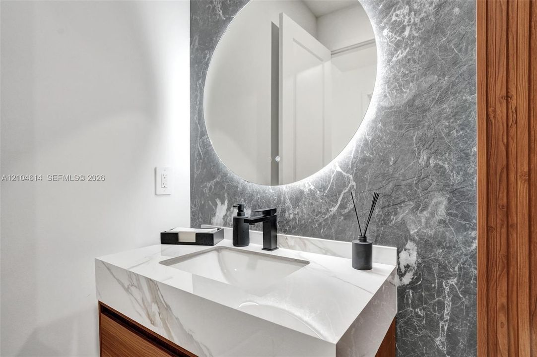 Floating vanity with an integrated sink and white stone look countertop