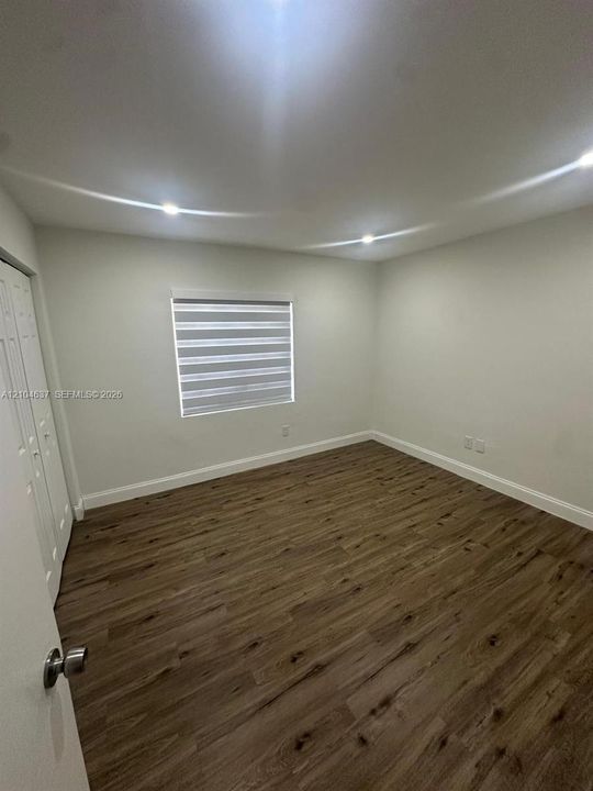 Recessed lighting, wood-finish flooring, and window treatments