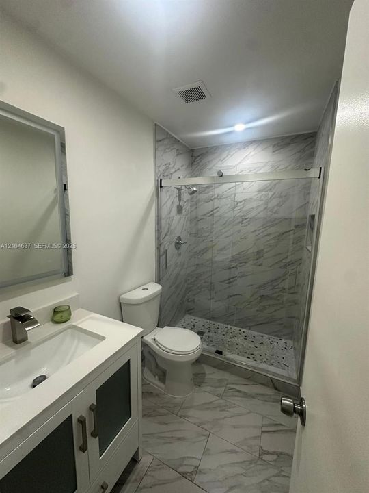 White vanity with integrated sink and chrome faucet