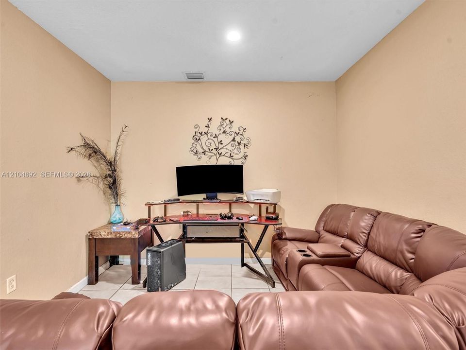 Neutral-toned interior room featuring tile flooring and recessed ceiling lighting