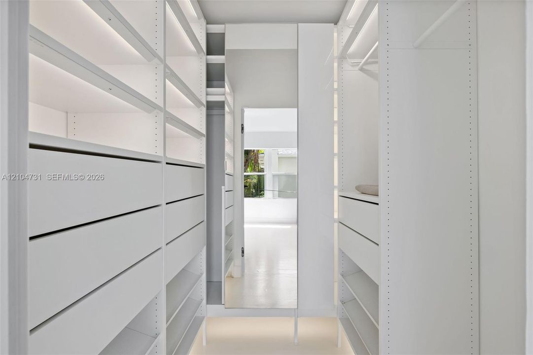 Integrated custom closet system featuring shelving, drawers, and hanging rods
