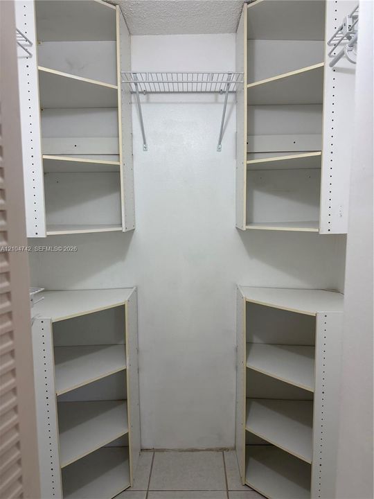 Built-in closet system with adjustable shelving, wire rack, and hanging rod