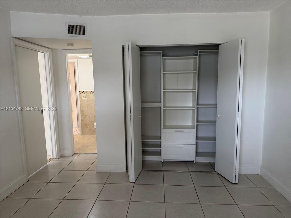 Built-in closet system with shelves and drawers