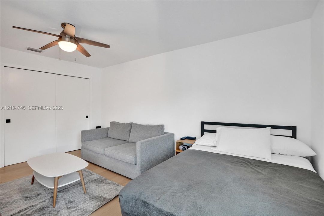 Wood-finish flooring with a ceiling fan light fixture
