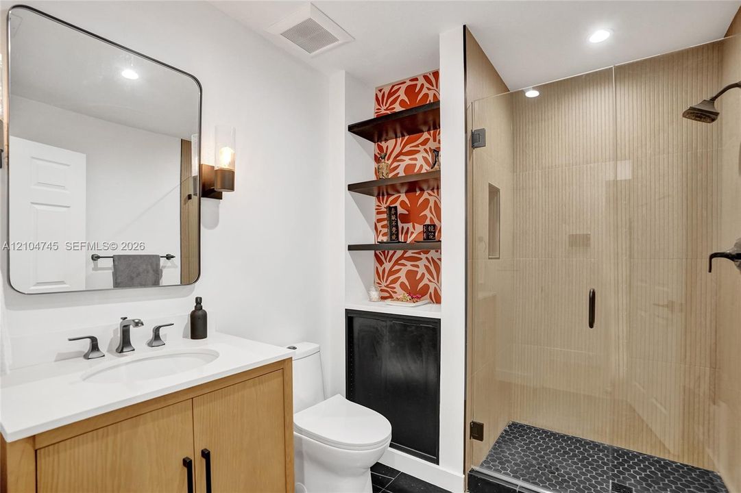Wood-finish vanity with integrated sink and chrome hardware