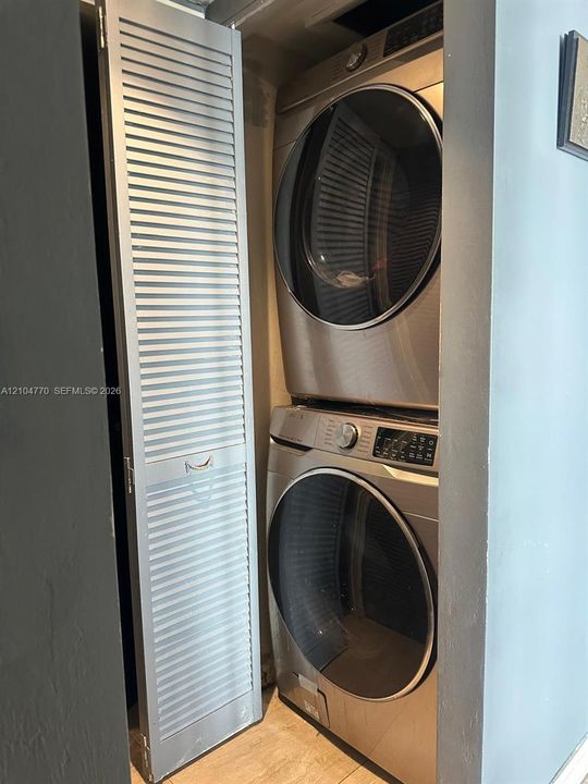 Stacked washer and dryer unit
