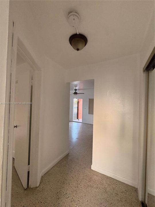 Hallway with terrazzo flooring and a flush-mount light fixture