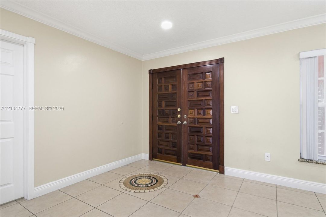 Double entry doors with intricate wood paneling